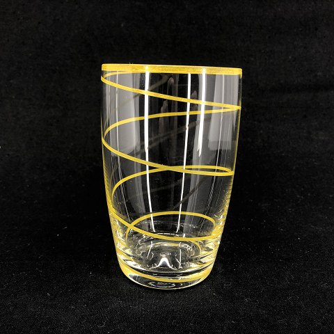 Drinking glass with yellow stripe by Jacob E. Bang
