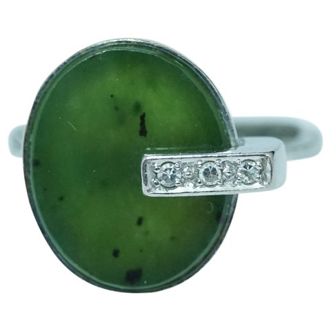 A ring of 14k white gold set with jade and diamonds