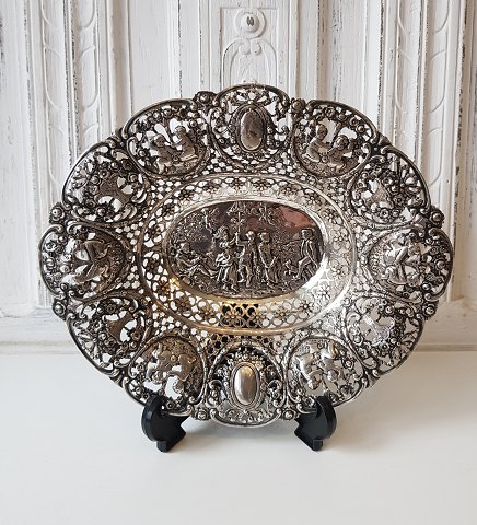 Large silver bowl with openwork edge richly decorated with rococo scenery