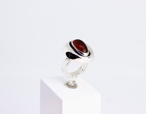 Ring of 925 sterling silver decorated with a piece of amber and stamped by N.E. 
From.
5000m2 showroom.