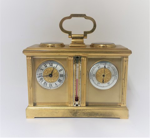 English travel clock with weather station. There are clock, barometer, compass 
and thermometer. Length 16.5 cm. Clockwork works. Winding key included.