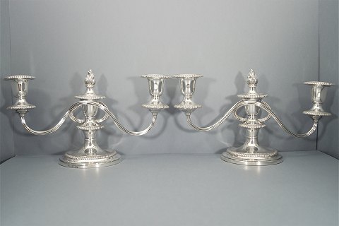 A pair of three armed candlesticks of gilt silver, England