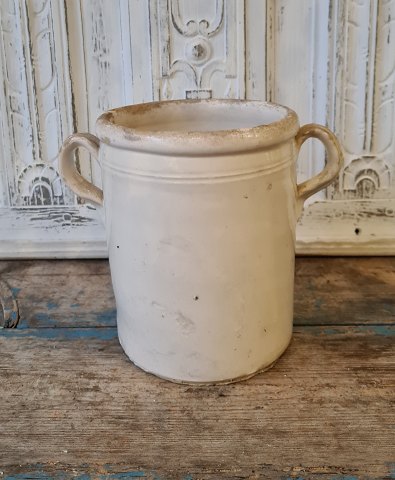 Beautiful old pottery jar with beautiful cream-colored glaze. 19 cm.