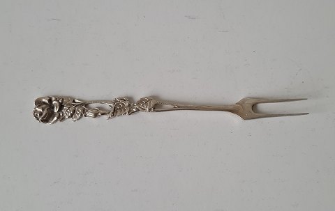 Silver fork decorated with rose