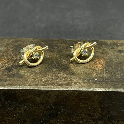 A pair of ear studs with small stones