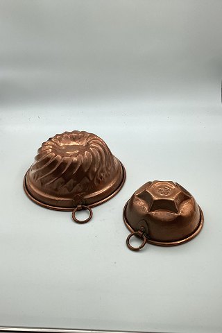 Two copper pudding molds with crown stamp