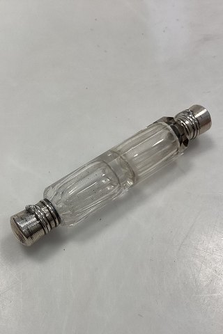 Double perfume bottle with silver mounting. Faceted glass. In good condition. 
Glass stopper at one end. Unstamped silver. Length 10 cm.

