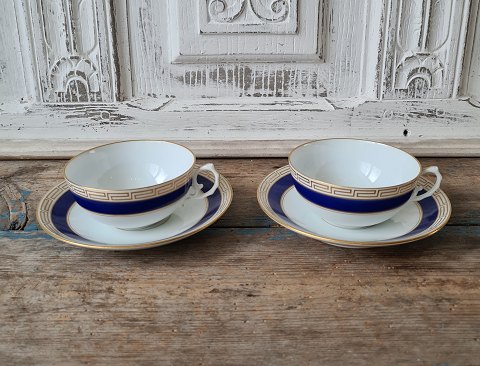 Set of 11 B&G teacups decorated with royal blue, Greek eternity pattern and coat 
of arms in gold.