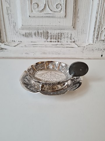 Oriental tea strainer on tray in sterling silver