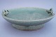 Arne Bang; A stoneware dish on a  small foot in light green glaze  decorated 
with two snakes #137