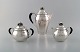 L'Art presents: 
Rare Georg 
Jensen coffee 
service in 
sterling silver 
with ebony 
handles. Coffee 
pot, sugar bowl 
...