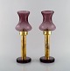 HANS-AGNE JAKOBSSON for A / B MARKARYD. A pair of tall vintage oil lamps in 
brass and purple art glass. 1960 / 70