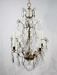 Chandelier of brass and polished prisms from France around the 1920s.
5000m2 showroom.