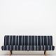 Hans J. Wegner / Johannes Hansen
Rare sofa with patinated oak legs, newly upholstered in textile (DAW, color 
Stripe 7)
1 pc. in stock
Renovated
