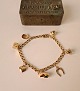 Vintage Bismarck bracelet in 14 kt gold with seven charms