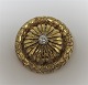 Guld broche med diamant i 18K guld (750). Diamant ca. ...