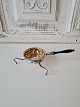 Antique tea strainer in silver with wooden handle
