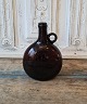 19th century brandy jug in manganese colored glass
