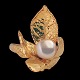 Jean Larsen; A ring of 18k gold set with a pearl