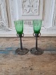 Pair of Art Nouveau shot glasses. The cup is made of ground green glass mounted 
on a pewter foot