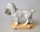 Porcelains 
figur af 
puddelhund med 
kurv, 19. årh. 
Tyskland