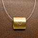 Necklace with a 14k gold pendant set with diamond