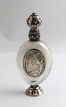 Perfume flacon with silver mounting. Height 10.5 cm. There are traces of use on 
the silver.