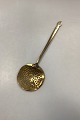 Antique brass skimming spoon