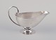 L'Art 
præsenterer: 
Johan 
Rohde 
(1856-1935) for 
Georg Jensen. 
Sovsekande af 
sterlingsølv. 
Hammerslået 
kande med ...