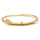 Ole Lynggaard Snakes armring. Oplukkelig oval armring i 18kt guld prydet med i 
alt 5 brillanter på i alt ca. 0,06ct. Stemplet Ole Lynggaard. Indvendige mål: 
5,9x4,8cm