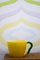 K&Co. præsenterer: Ursula kaffekop i fajance fra Royal Copenhagen designet af Ursula Munch-Petersen i gul glasur...