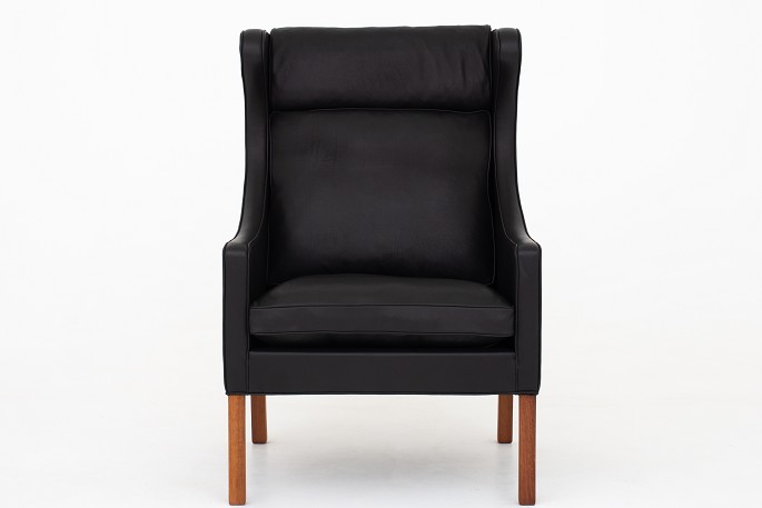 Børge Mogensen / Fredericia Furniture
BM 2204 - Nybetrukket øreklapstol med sort Pleasure-læder. KLASSIK tilbyder 
polstring af stolen med stof eller læder efter eget ønske.
Leveringstid: 6-8 uger
Ny-restaureret
