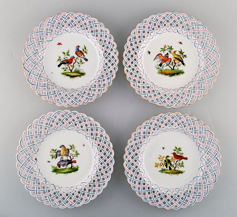 Four antique pierced Meissen plates with hand painted bird motifs. Mid 19th 
century.
