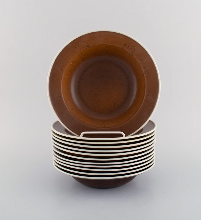 Stig Lindberg for Gustavsberg. Twelve Coq deep plates. Beautiful glaze in brown 
shades. Swedish design, 1960s.
