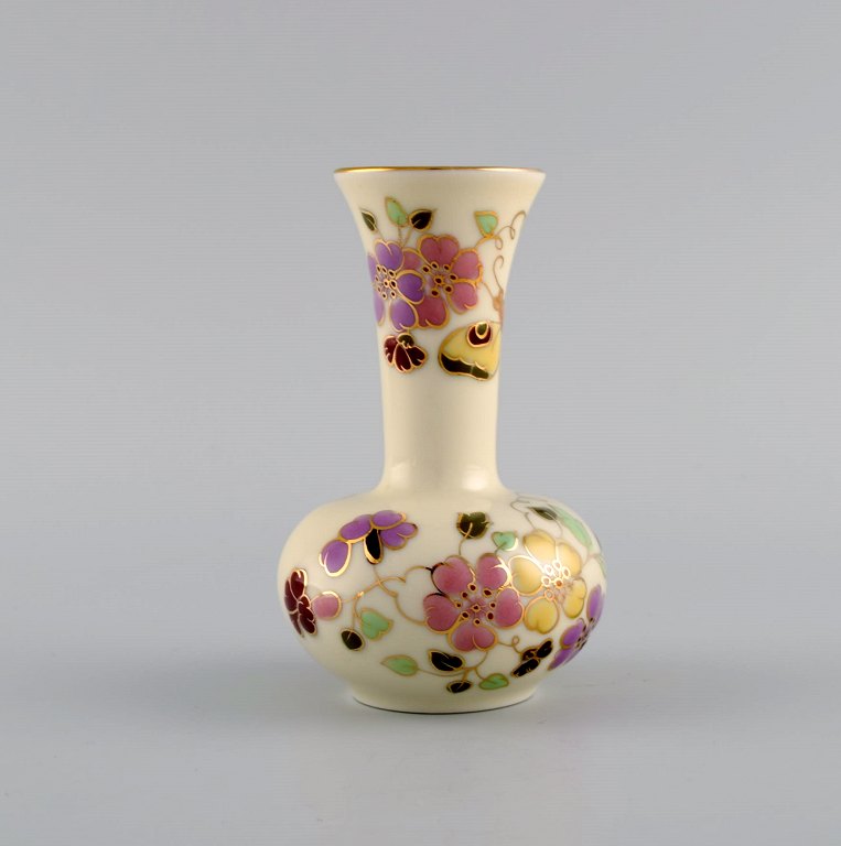 Zsolnay vase in cream-colored porcelain with hand-painted flowers, butterflies 
and gold decoration. Late 20th century.
