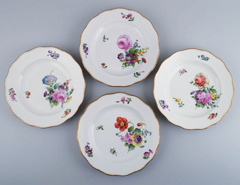 Royal Copenhagen Sachian Flower. Four dinner plates with hand-painted flowers 
and gold decoration. Approx. 1900.