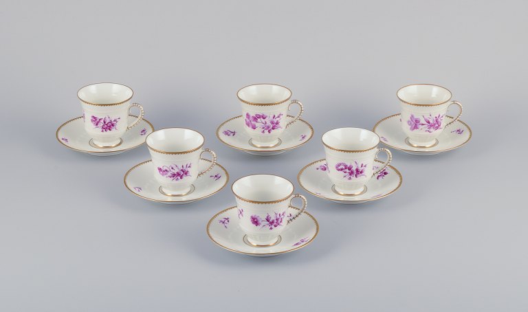 Bing & Grøndahl, Denmark. A set of six coffee cups and saucers with flower 
decorations in purple and gold trim. Hand-painted.