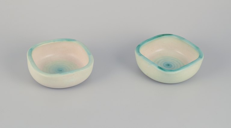 Elchinger, France. Two ceramic bowls with light-toned glaze. Hand-decorated. 
Spiral-shaped decoration.