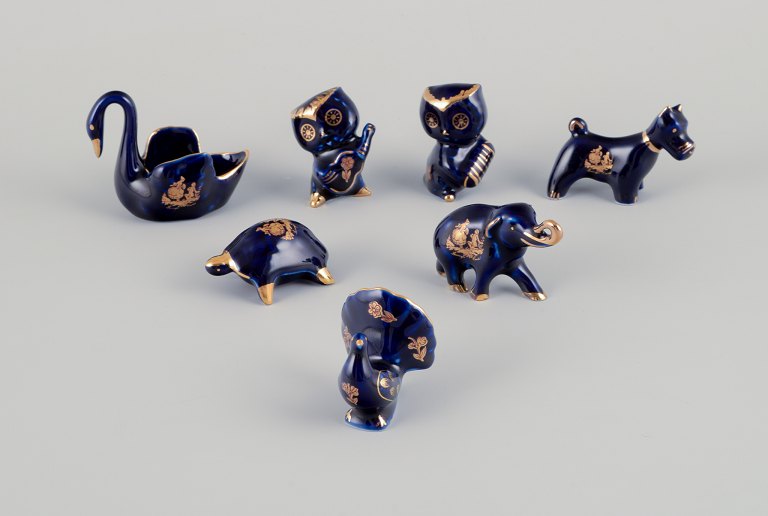 Limoges, France. Seven miniature porcelain animals, decorated with 22-karat gold 
leaf and a beautiful royal blue glaze. Scène galante.