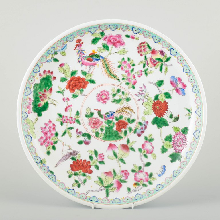 China, Tongzhi (1862–1874), 19th century.
Large porcelain dish, decorated with flowers, fruits, and birds in famille rose 
enamels.