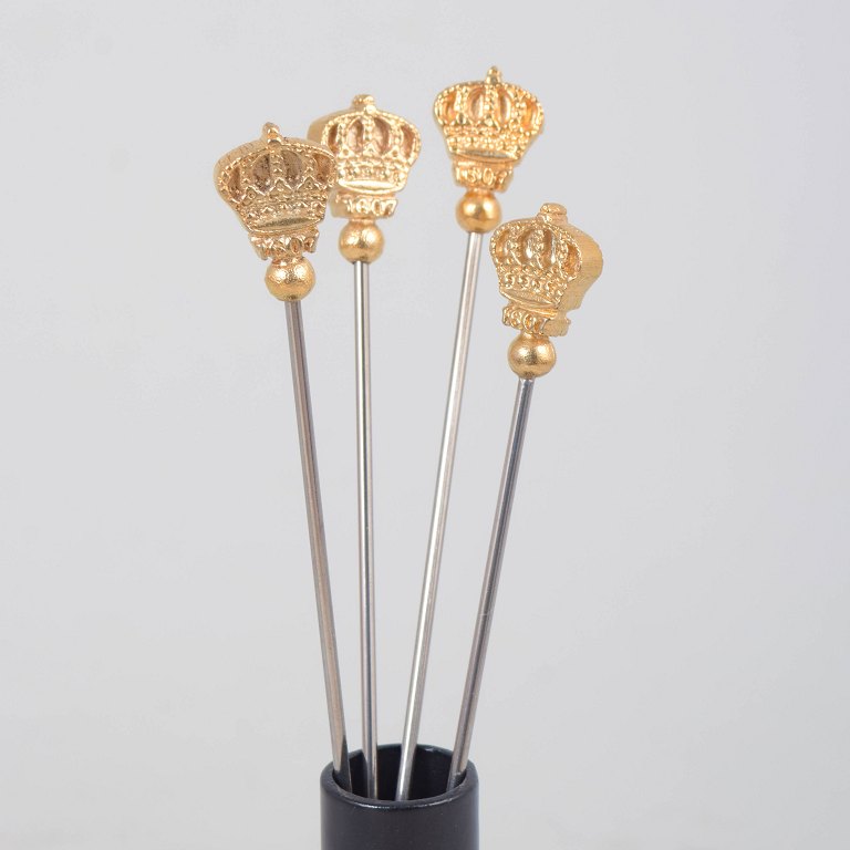 Skultuna, set of four cocktail sticks with crown motif.