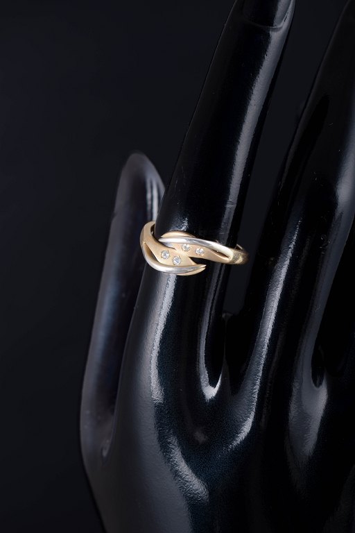 8 carat gold ring with four white stones.