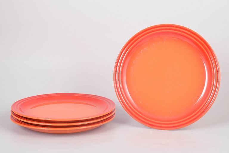 Le Creuset, set of four dinner plates.